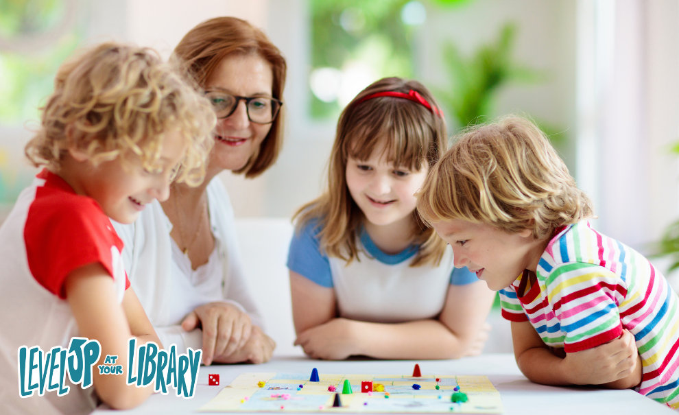 family looking over a board game on table