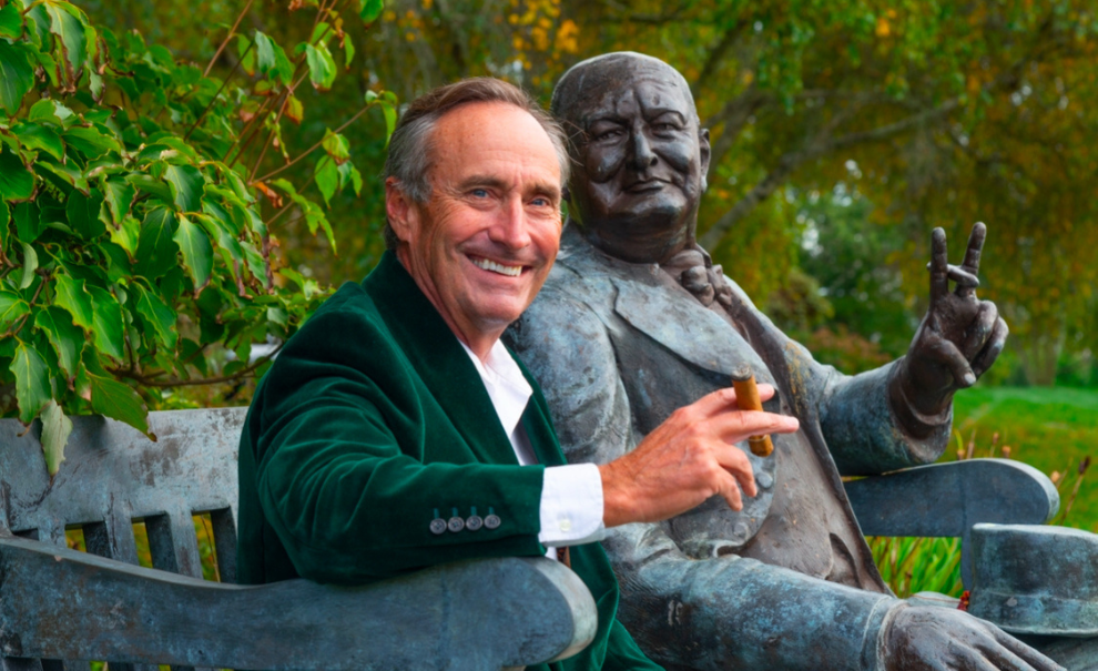 image of jim pierce with his arm around a winston churchill statue.