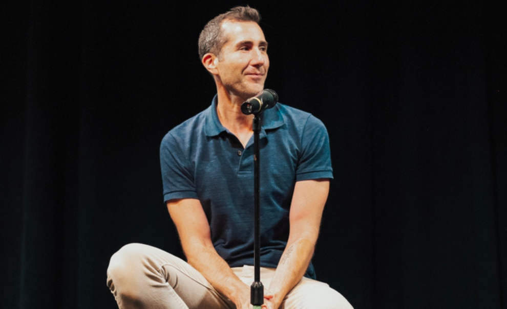 dave solomon sitting on chair on stage