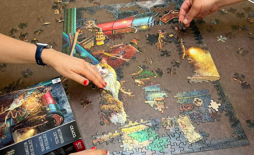 Hands working on puzzle