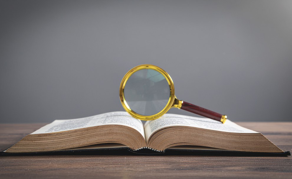 Magnifying glass balanced on an open book