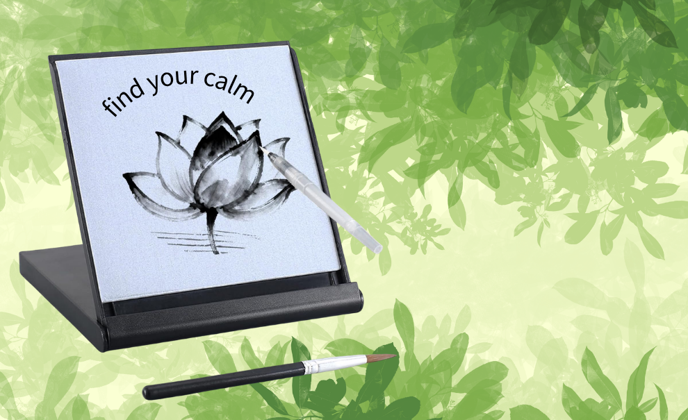 Zen Meditation Drawing Board and brushes in front of a calm background of impressionistic green leaves.