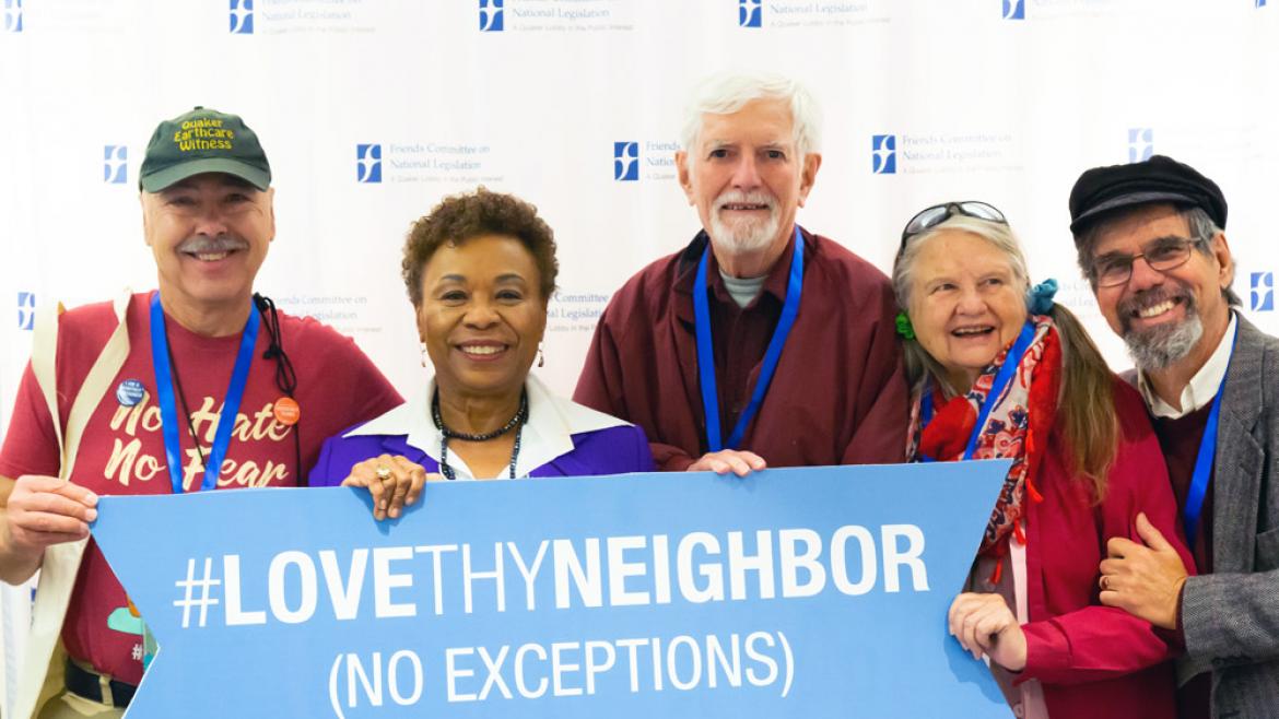 lovethyneighbor sign held by smiling people
