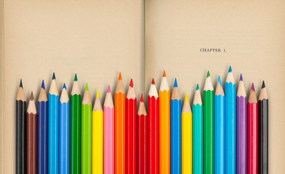 colored pencils in front of book page reading "chapter 1"