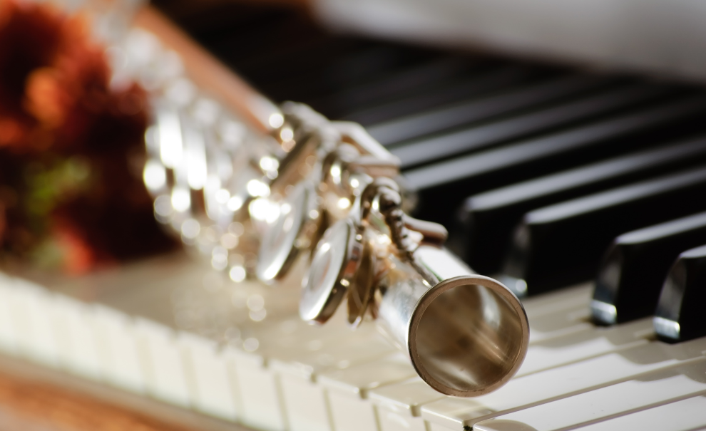 flute sitting on top of piano keys