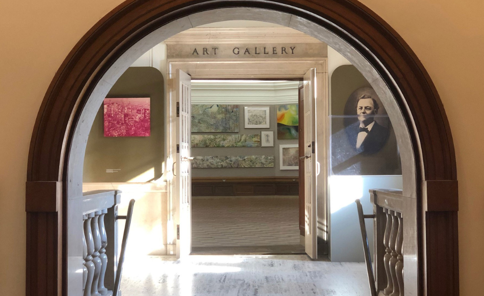 arched entryway into hoxie gallery with portrait images on the wall
