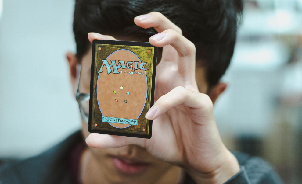Teen holding Magic the Gathering card