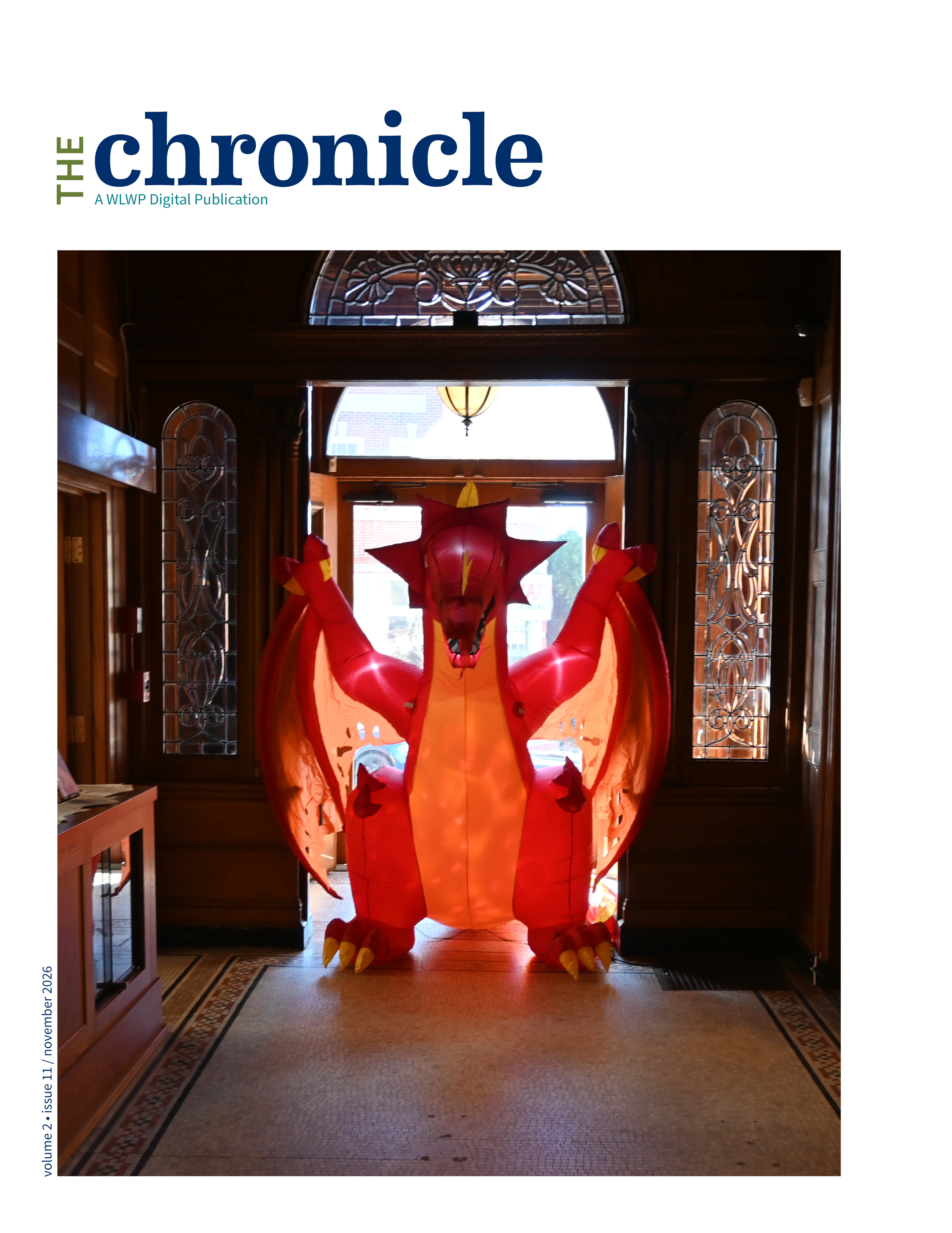 inflatable dragon in front of old wooden doors with stained glass