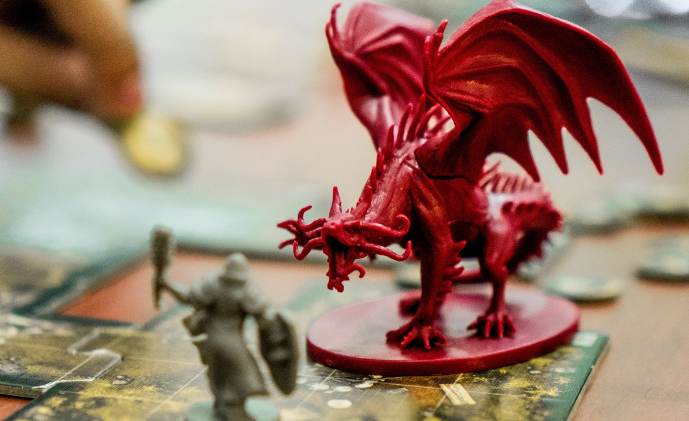 Dragon and knight mini-figures on game board