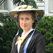 headshot of woman in hat