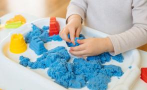 image of child playing with kinetic sand