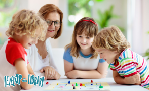 family looking over a board game on table