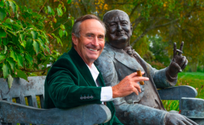 image of jim pierce with his arm around a winston churchill statue.