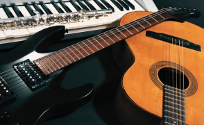 A juxtaposition of an electric keyboard, a clarinet, an electric guitar, and an acoustic guitar in natural color.