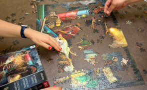 Hands working on puzzle