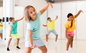 kids moving with arms raised