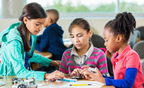 Three tweens working in a makerspace
