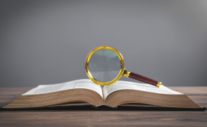 Magnifying glass balanced on an open book