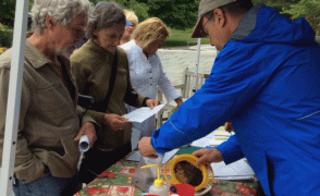 people bringing soil sample to a kiosk