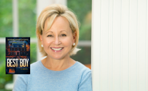 Deborah Goodrich Royce leaning against a wall with the best boy book cover to her left