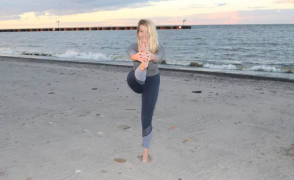 woman doing a yoga pose on the beach