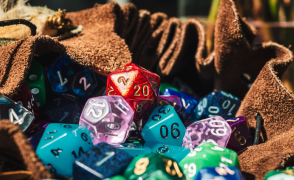 A leather bag full of various multicolored polyhedral dice