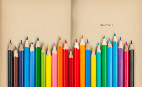 colored pencils in front of book page reading "chapter 1"