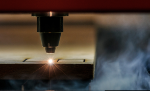 A laser cutter engraving a piece of wood