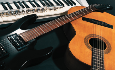 A juxtaposition of an electric keyboard, a clarinet, an electric guitar, and an acoustic guitar in natural color.