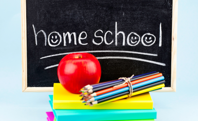 chalkboard with the words "homeschool" a pile of books and an apple
