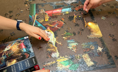 Hands working on puzzle