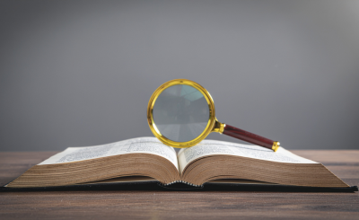 Magnifying glass balanced on an open book