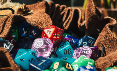 A leather bag full of various multicolored polyhedral dice